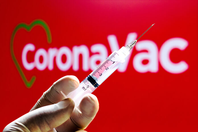 In this photo illustration a medical syringe seen with