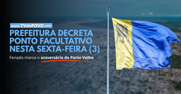 Bandeira de Porto Velho tremulando sobre a cidade com chamada sobre ponto facultativo decretado pela Prefeitura.