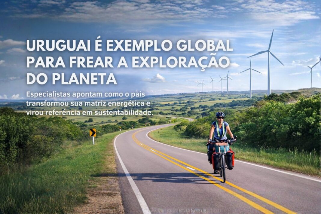 Ciclista em estrada rural no Uruguai com turbinas eólicas ao fundo, representando sustentabilidade e transição energética.